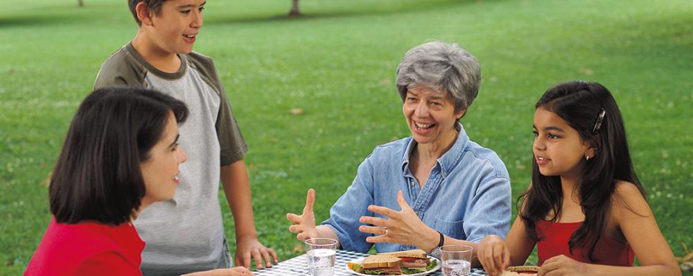 family at picnic table at park