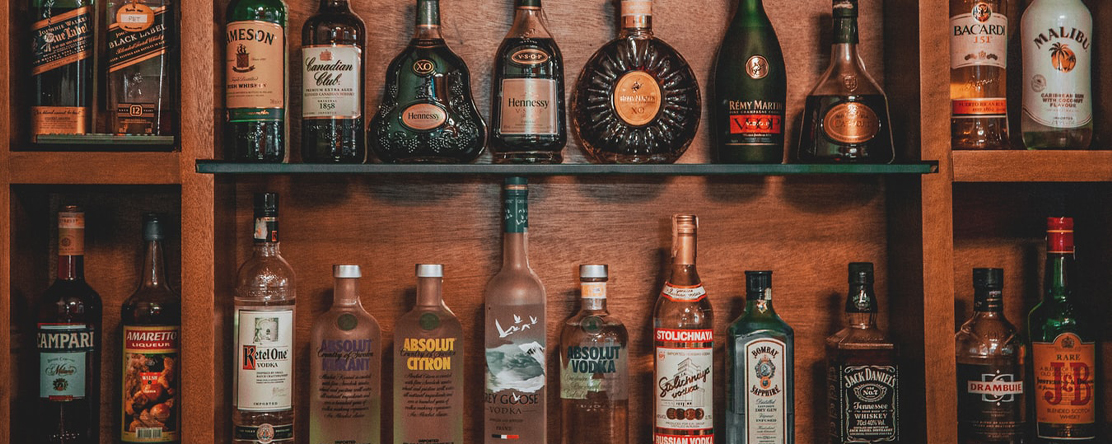 liquor bottles on shelves at a bar