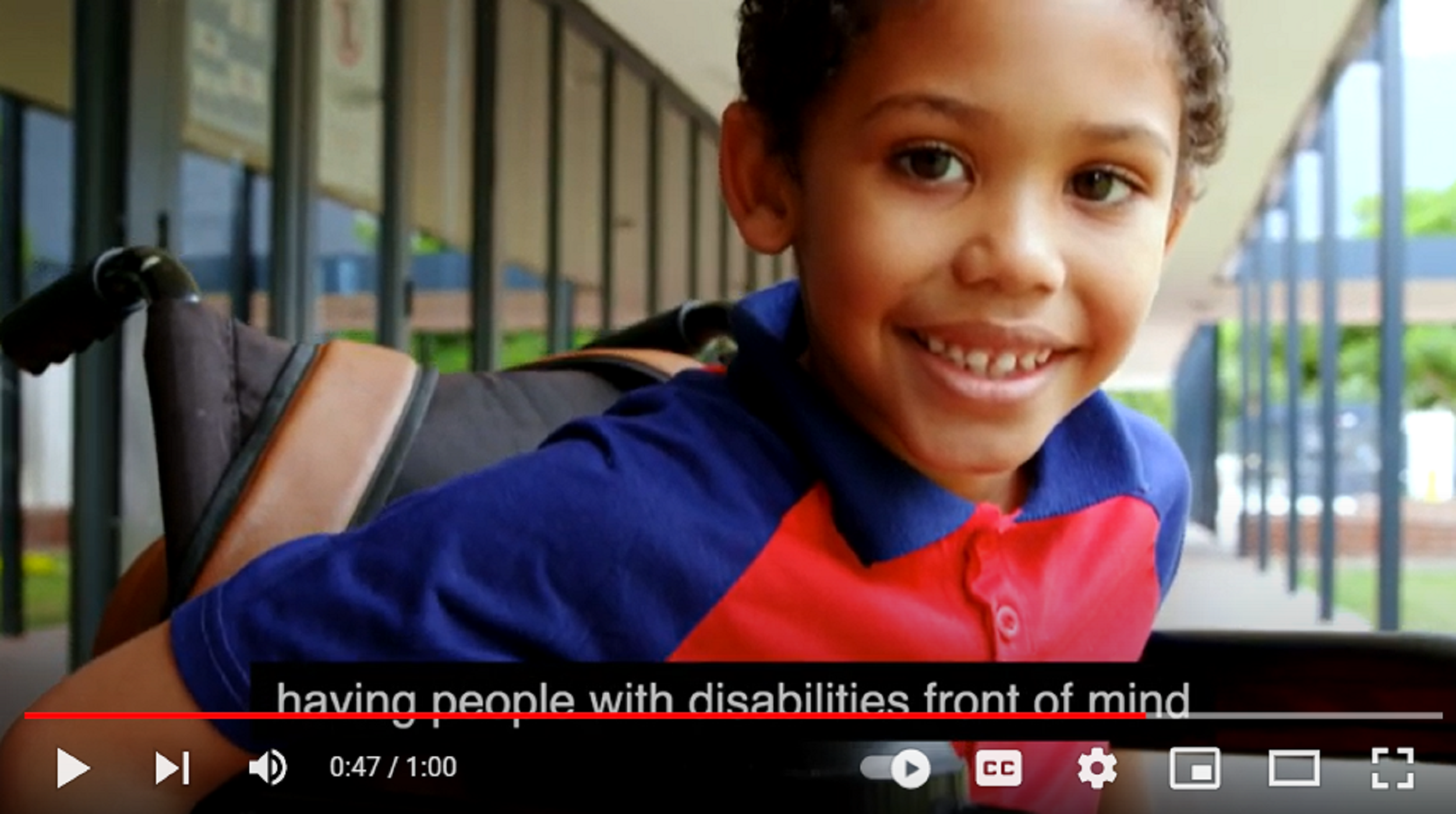 Screenshot from video: Boy in wheelchair, smiling at camera