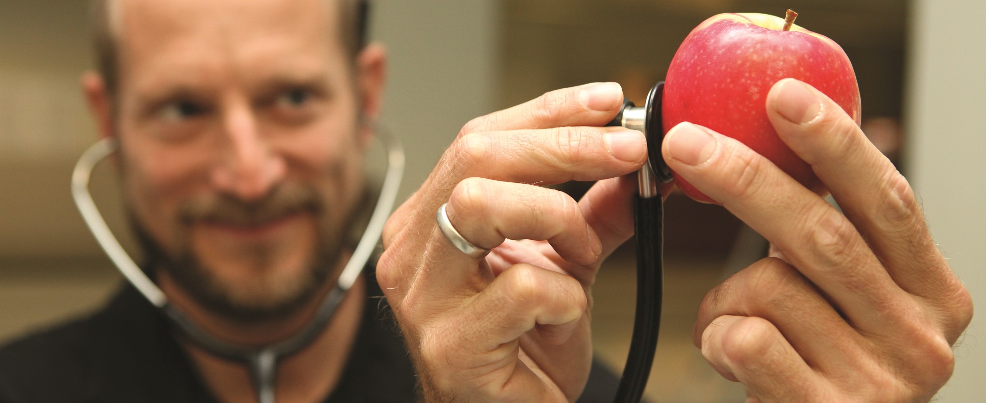 doctor holding a stethoscope and an apple