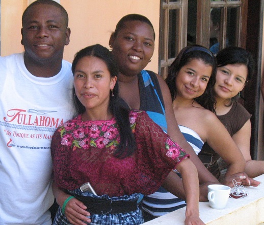 GoJoven International youth participants, smiling and standing on a balcony