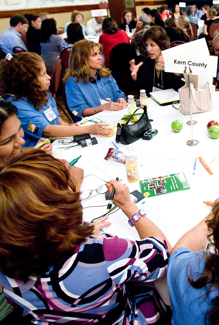 group of people sitting around a round table