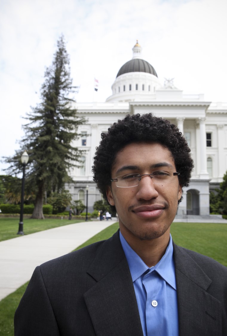 young man in front of white government building