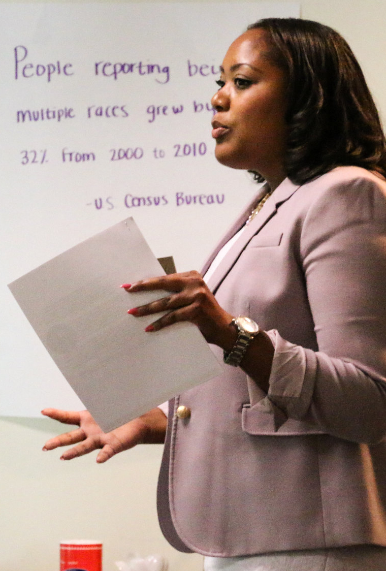 woman holding paper in front of white board