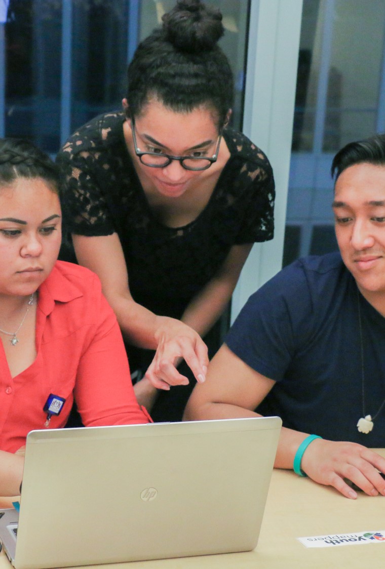 3 people looking at laptop computer screen