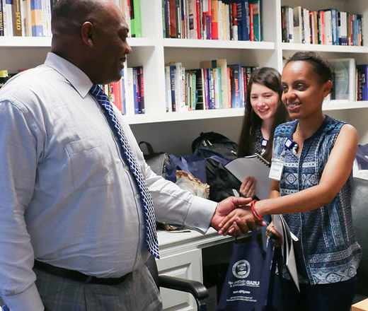 Man shaking young woman's hand