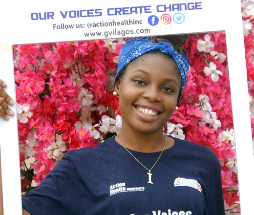 girl holding frame that says "Our voices create change"