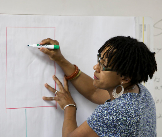 Woman drawing on white board