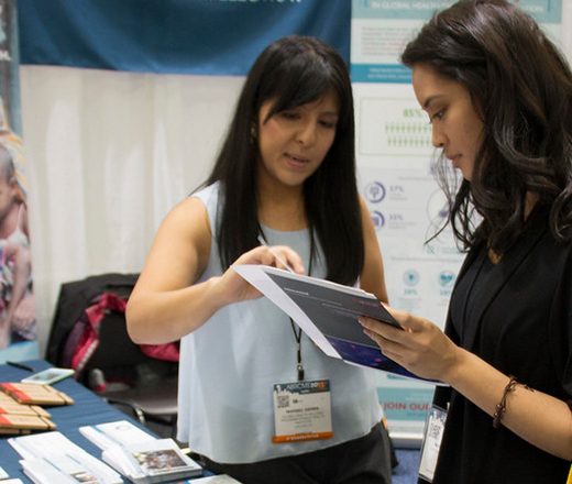 Woman showing another woman a guide