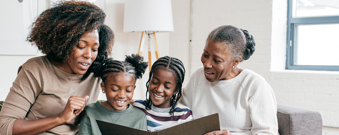 Three generations of women reading together