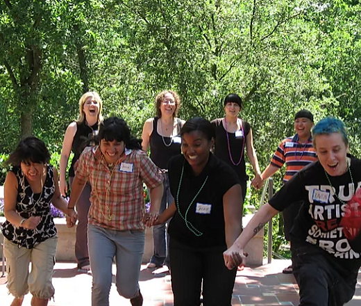 CCP youth participants holding hands and running towards the camera