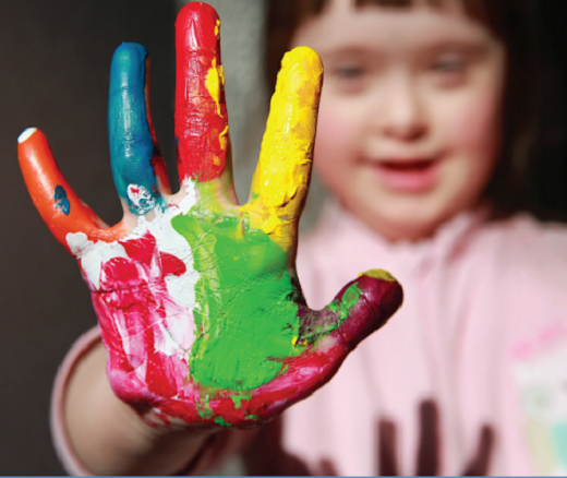 Young girl with colorful paint on her hands