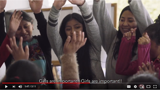 Screenshot of girls with hands raised above their heads in celebration, saying "Girls are important!"