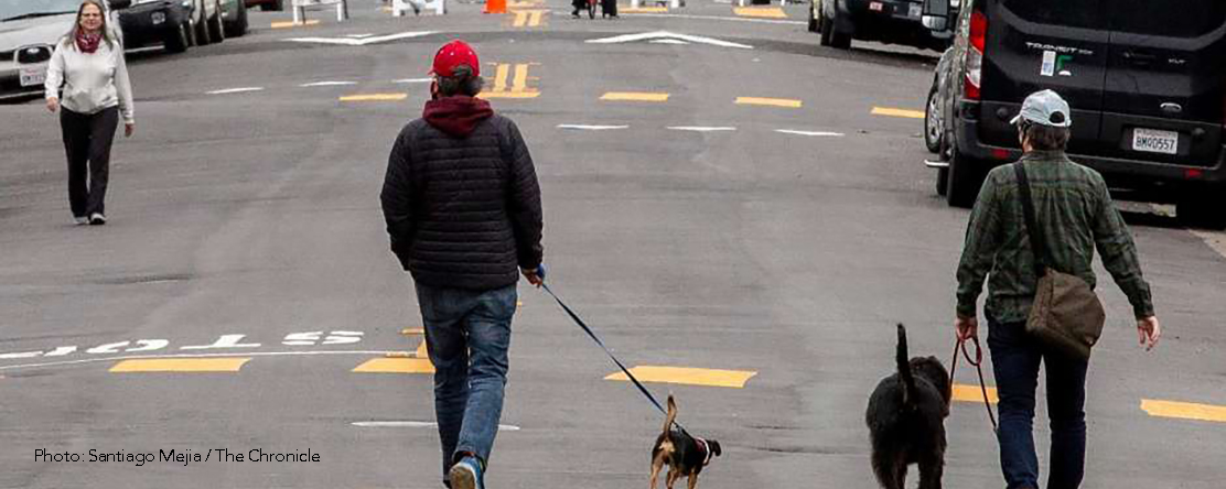 People along the closed 42nd Street off Broadway in Oakland