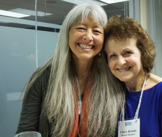 Serena Clayton and Claire Brindis, arms around each other, smiling at camera