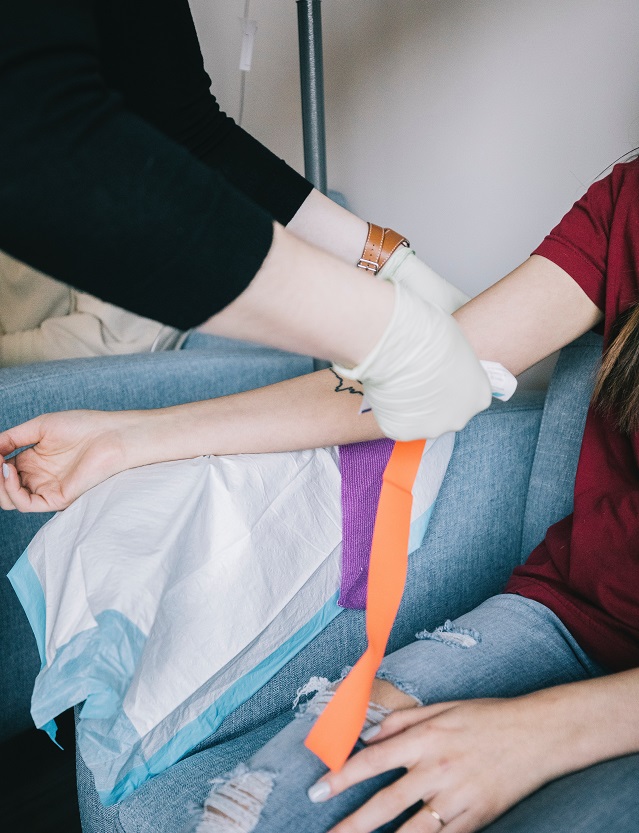 Woman getting her blood pressure taken by a medical worker.