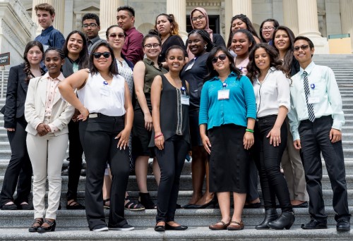 a group of young people in business clothes stading on steps in washington dc