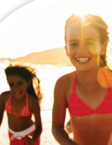 Two young kids at the beach on a sunny day