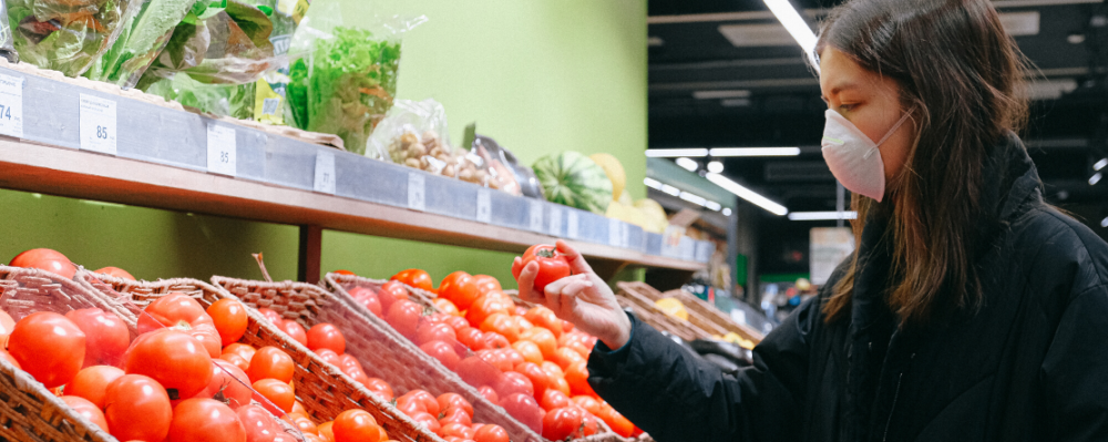 Woman in grocery store wearing a mask