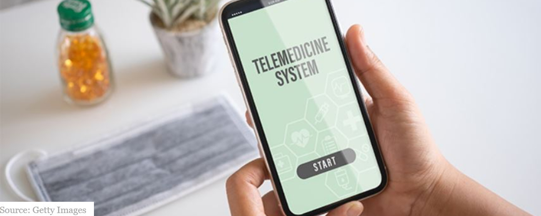 hands holding a phone with a screen reading "telemedicine system"