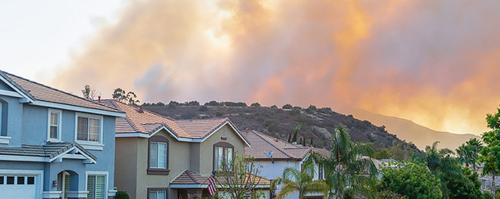 image: houses with smoke and fire in the sky