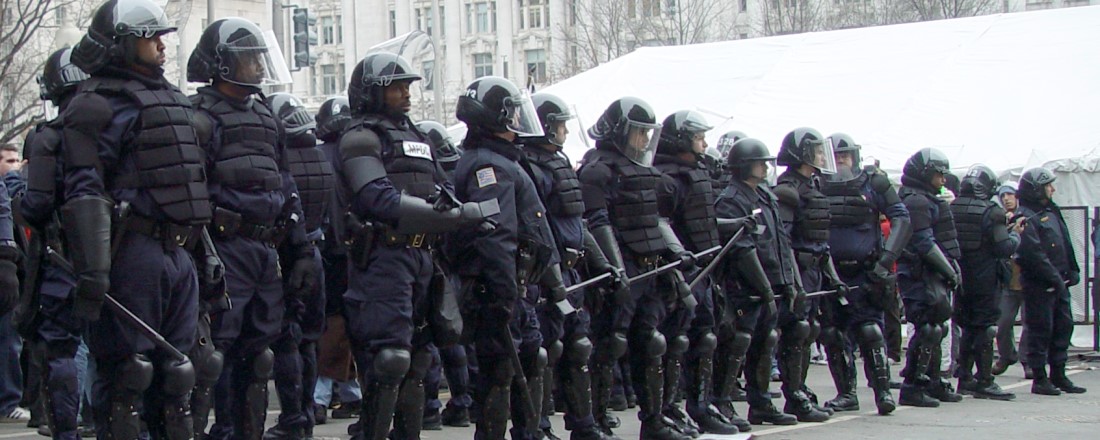 police officers dressed in riot gear standing in a line