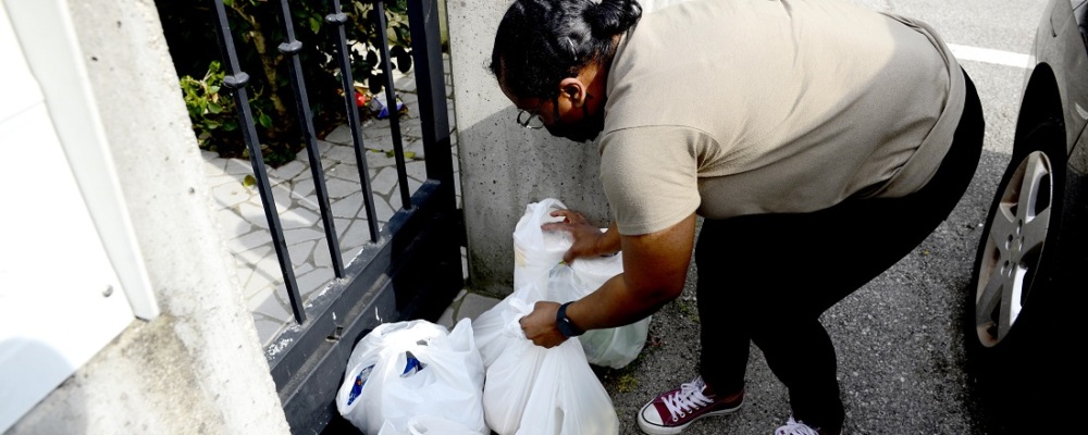 Woman delivering groceries outside