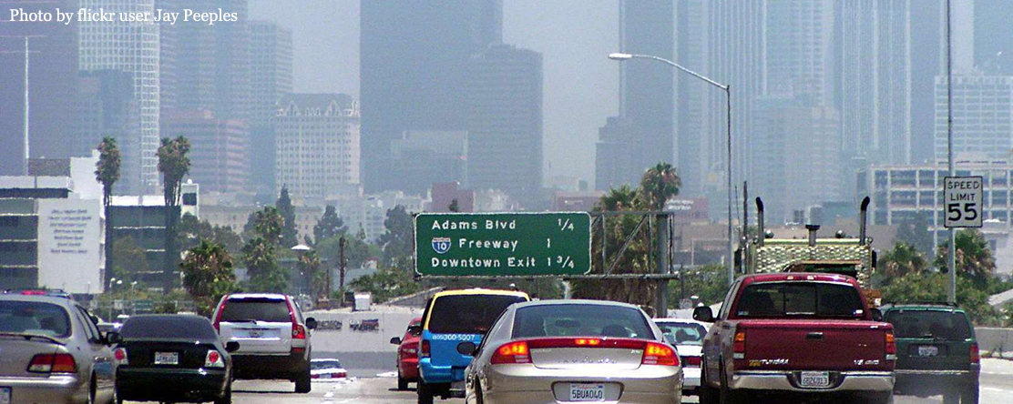 image of cars on road with polluted air in the city