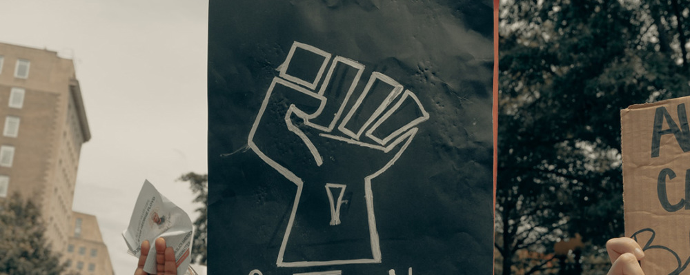 image: drawing of a fist at protest