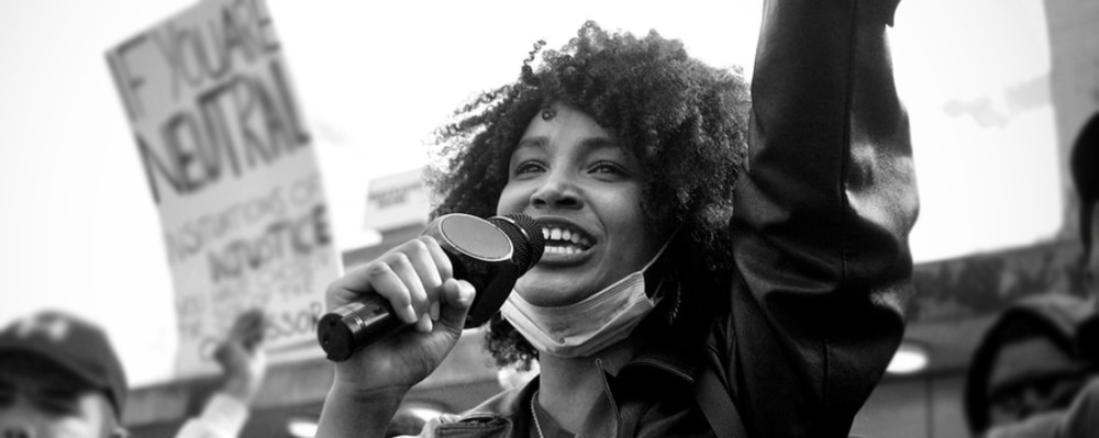 Woman holding a microphone at protest