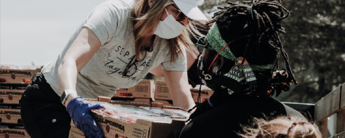 Women carrying supplies off a truck