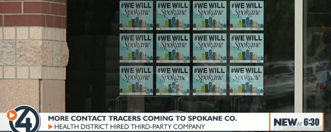 a door covered with signs reading #We Will Spokane