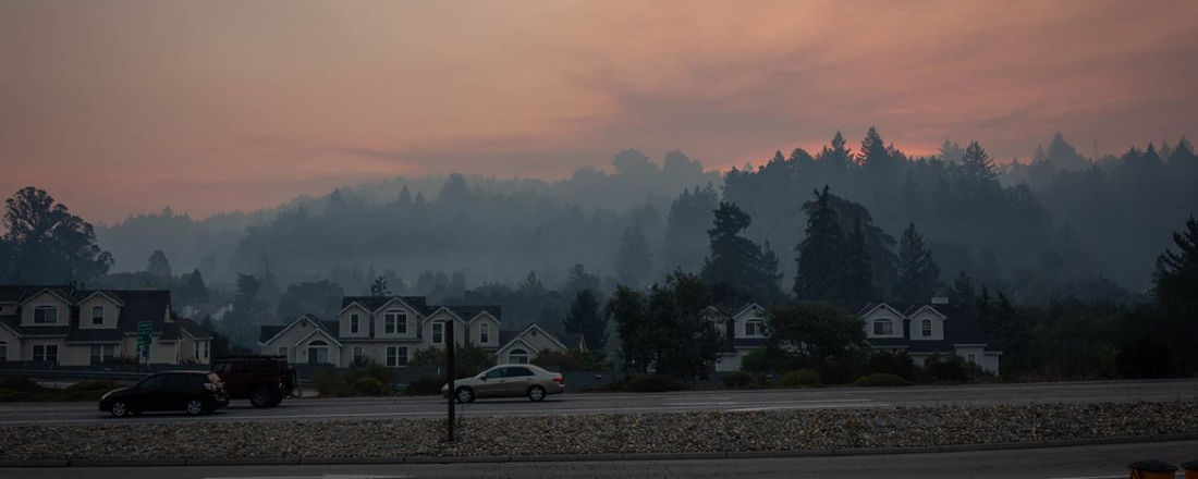 a smoky, hazy skyline behind homes