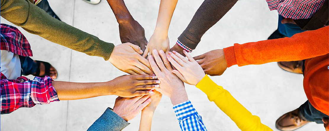 image: group of people's hands huddled together