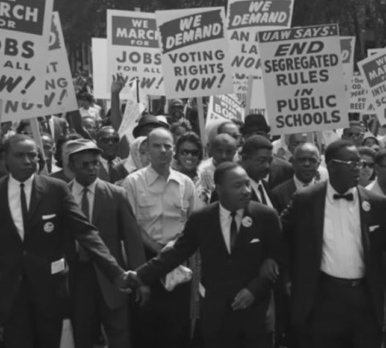 image: Martin Luther King Jr.marching at nonviolent protest