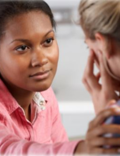 a young woman comforting another woman