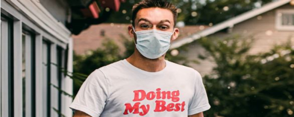 a young man in a mask wearing a t-shirt that says "doing my best"