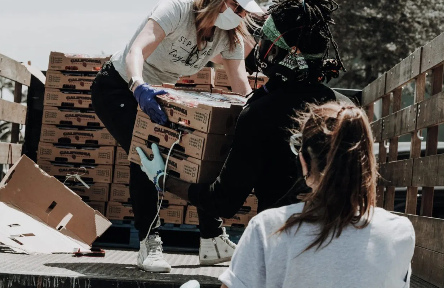 woman handing box to volunteer