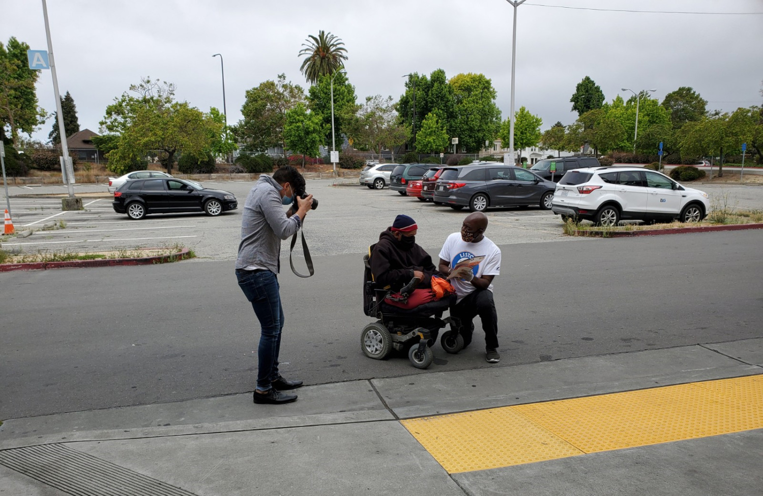man helping another man in wheelchair