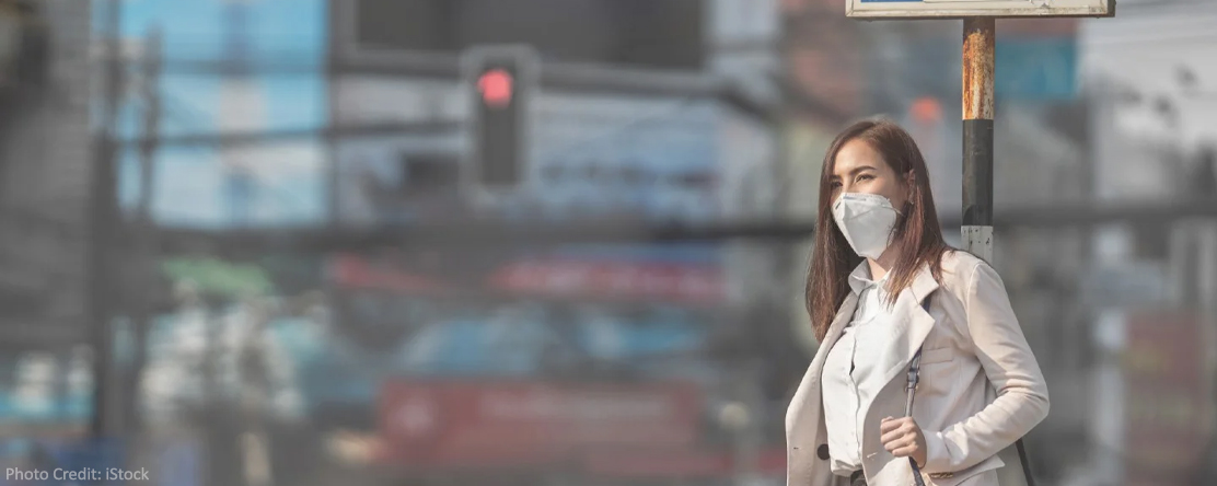 Woman wearing a mask near stoplight