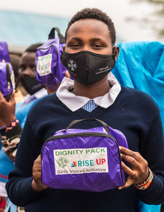 a young Rise Up leader holding a Rise Up "dignity pack"