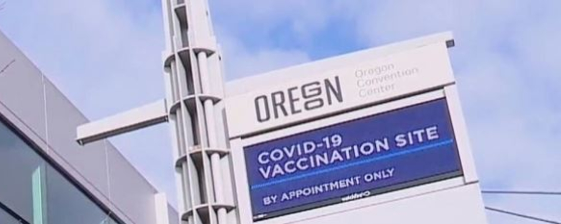 a street sign reading "Oregon COVID-19 vaccination site"