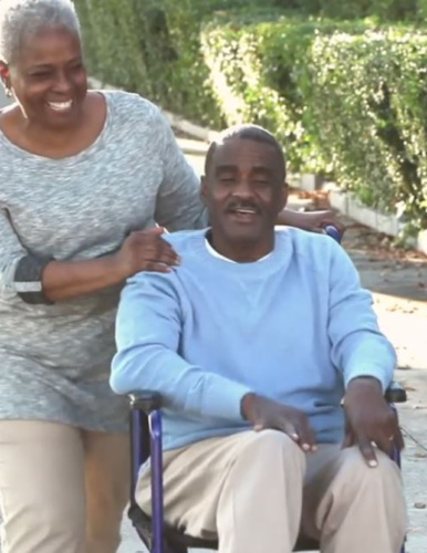 an older African-American couple with the man in a wheelchair