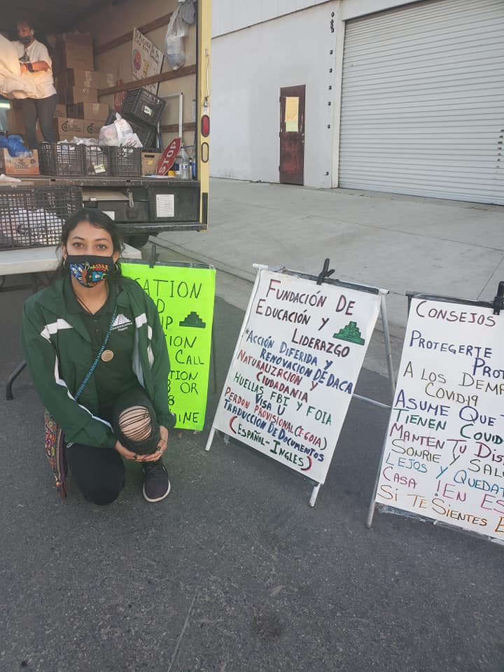 woman kneeling in front of signs