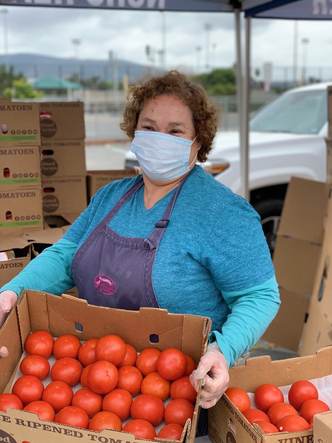 Woman with a box of oranges