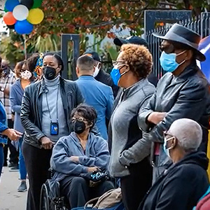 Black community, wearing masks, lining up for vaccine