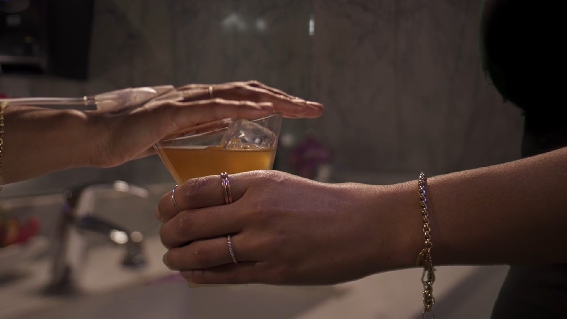 woman covering glass of alcohol