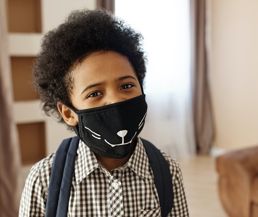 Child wearing a cloth COVID mask at school