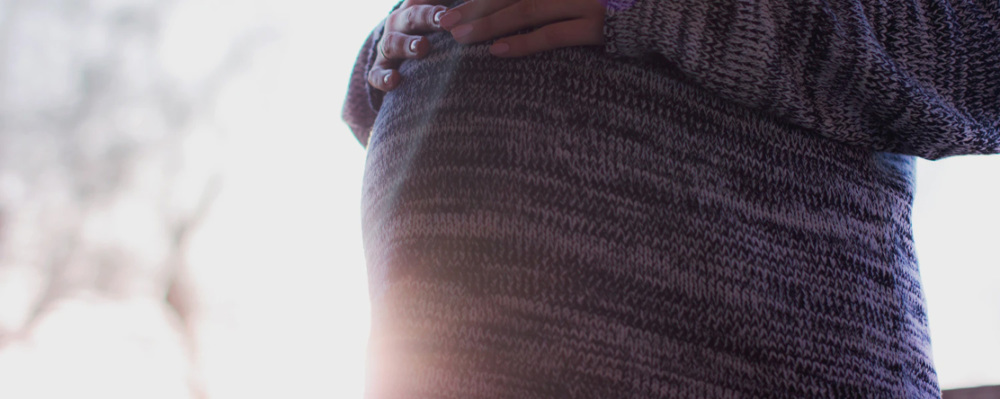 pregnant woman holding belly