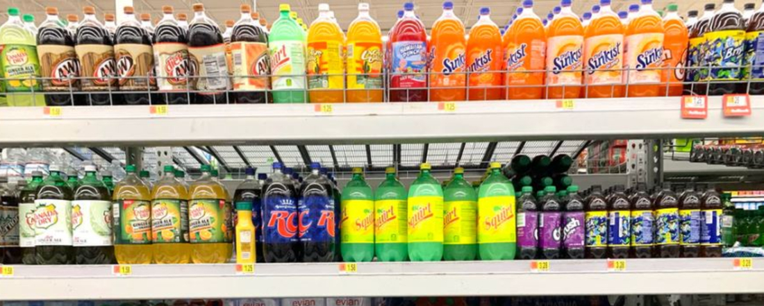 supermarket shelves with large bottles of soda